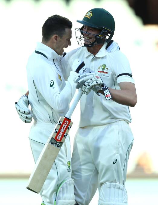 Matt Renshaw and Peter Handscomb celebrate the winning runs at Adelaide Oval. Picture: Getty Images