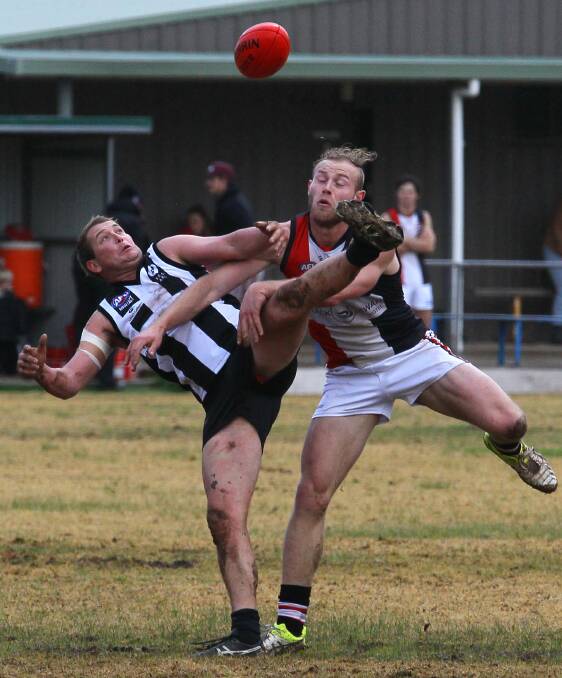 BALANCING ACT: TRYC's Mitch Leaver does his best on one leg while under pressure from North Wagga's Lachie Highfield. Picture: Les Smith