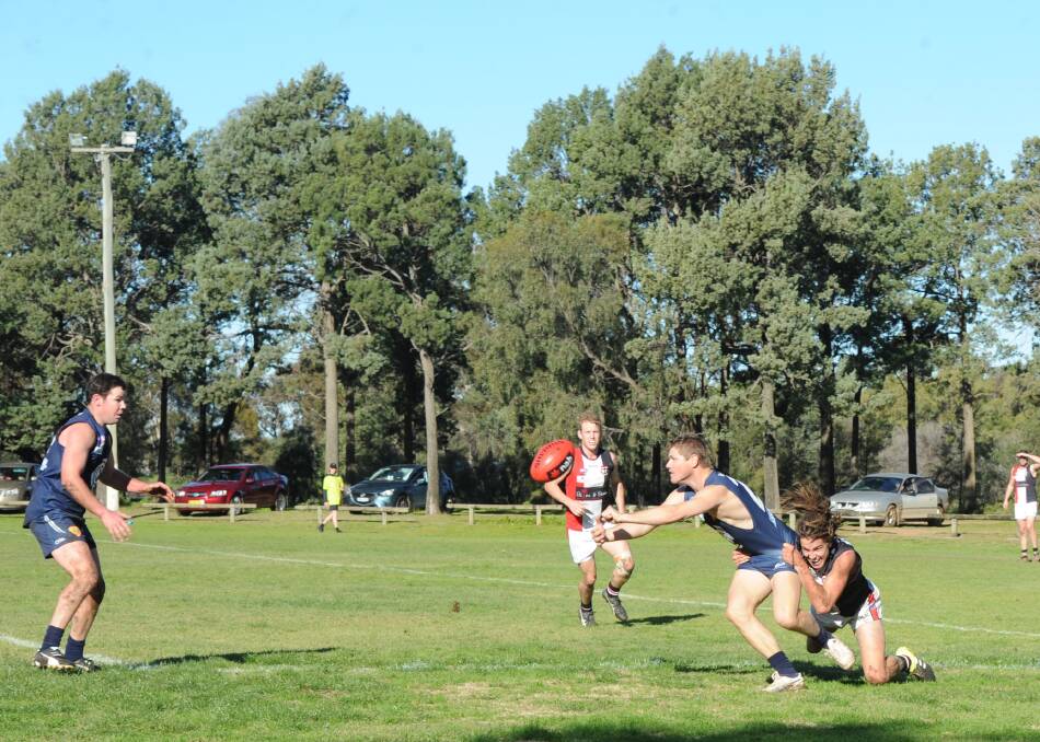 TOO GOOD: Coleambally's Tony Pound finds team-mate Simon Mackie despite the tackle of North Wagga's Ben Alexander. Picture: Riley Krause