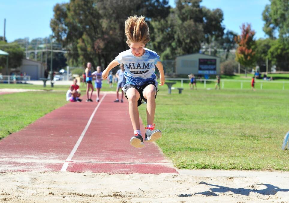 HAIR-RAISING EXPERIENCE: Charlotte Waring, 11, launches herself in the long jump at Wagga Public's athletics carnival. Picture: Kieren L Tilly