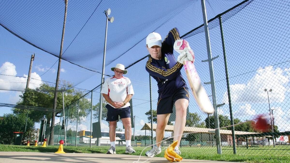 Warren Smith in 2010 working with then-Australian women's captain, Alex Blackwell. Picture: Les Smith