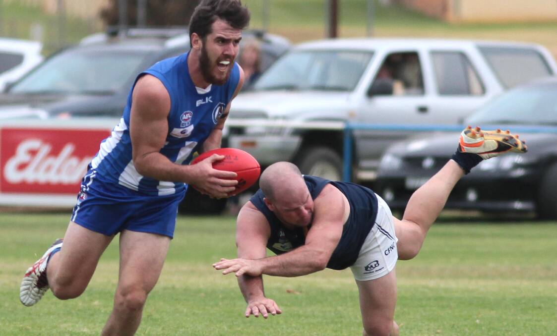 GOOD START: Temora's Kieran Shea gets clear of Coleambally's Mitch Carroll as the Roos kicked off their season with a win. Picture: Les Smith