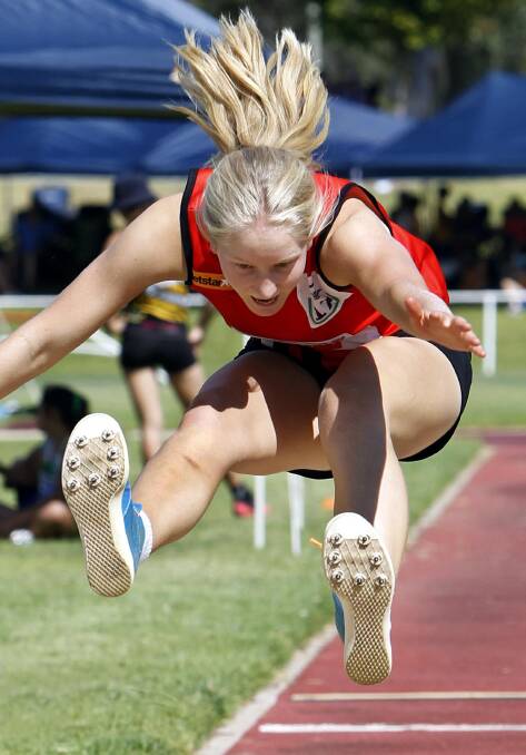 DETERMINATION: West Wyalong's Kate Payne, 16, competing in the triple jump on Saturday at Jubilee Park. Picture: Les Smith