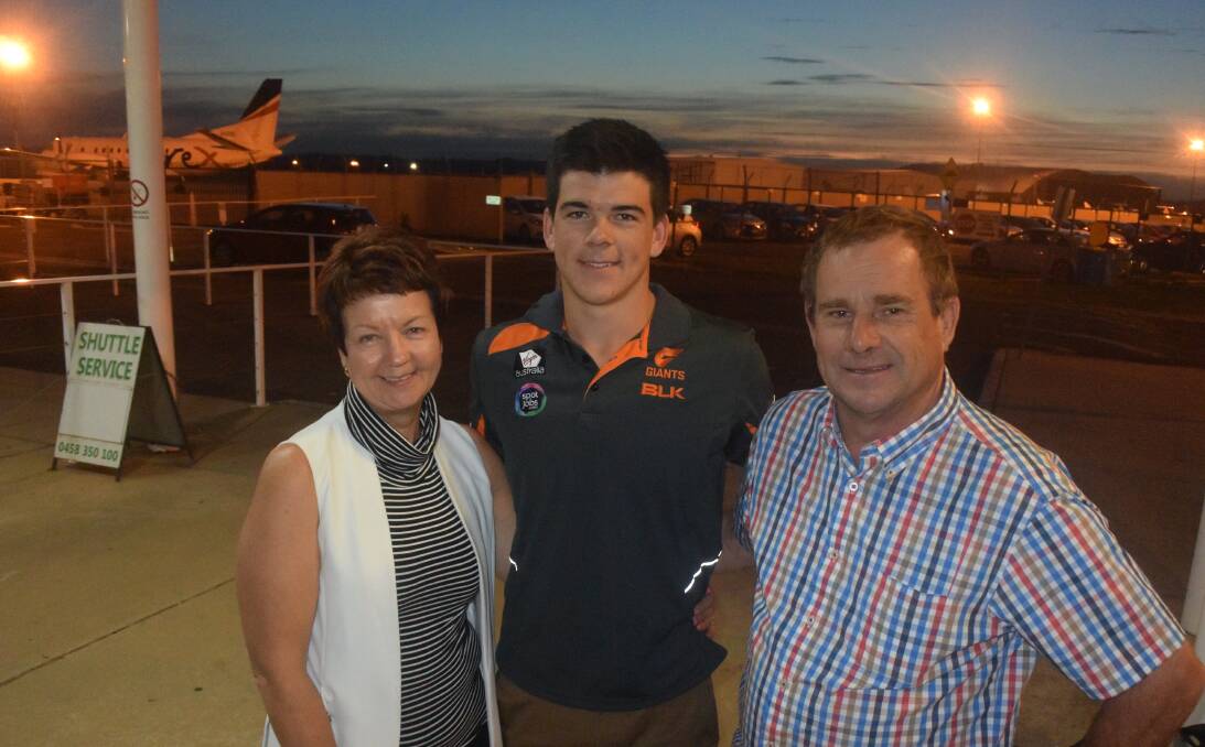 ON THE MOVE: GWS Giants recruit Matt Kennedy with mum, Vicki, and dad, Frank, at Wagga airport on Wednesday night after returning from the AFL Draft in Adelaide. Picture: Peter Doherty