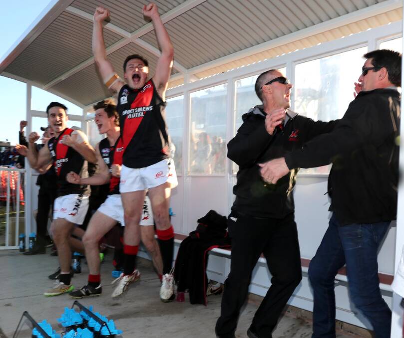 MOMENT OF ELATION: Marrar's Chris O'Donnell goes up as coach Shane Lenon and assistant Geoff Smith celebrate the Bombers' grand final win on Saturday. Picture: Les Smith