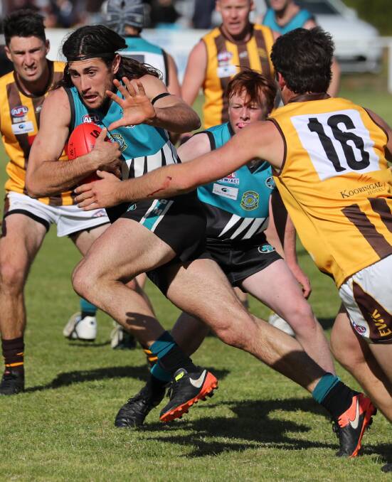 ON A MISSION: Northern Jets co-captain Mitch Haddrill gets the fend ready as Hawks midfielder Luke Cuthbert closes in at Ardlethan on Saturday. Pictures: Les Smith