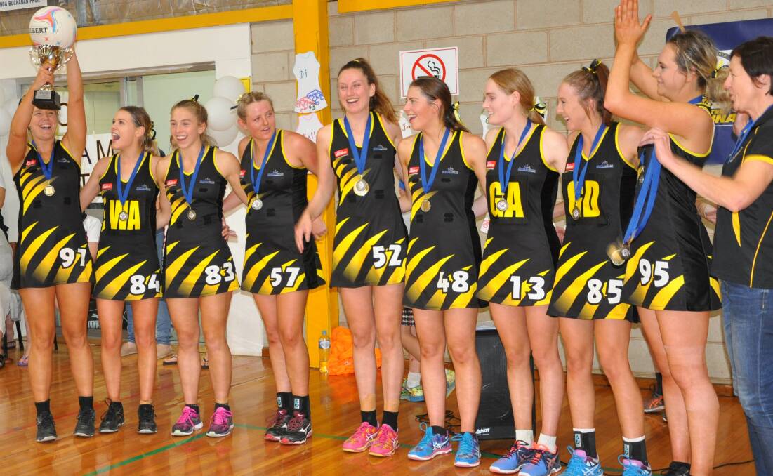 THE DOUBLE: Wagga Tigers celebrate consecutive A grade netball premierships after their nine-goal win over MCUE at Narrandera on Saturday. 