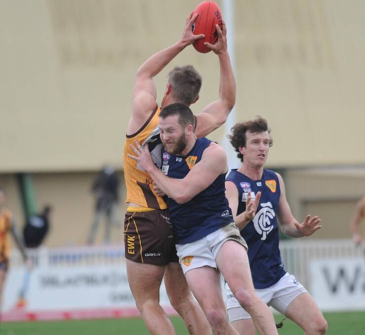 HEAVY BUMP: Coleambally's Todd Clark crashes into East Wagga-Kooringal's Sam Armstrong in the second quarter. It ignited tension between players. The three reports out of the game were from a separate third quarter blow-up. 
