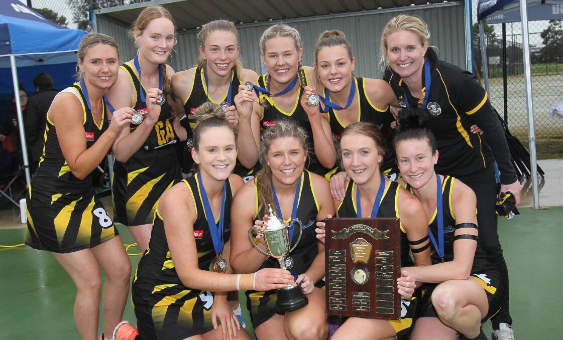 SPOILS OF VICTORY: Wagga Tigers A Grade netballers enjoy their grand final win over Collingullie-Glenfield Park on Sunday. Picture: Les Smith