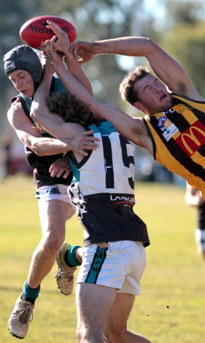 COLLISION: Northern Jets teammates Sam Robinson (left) and Jack Fisher collide as Hawk Luke Cuthbert spoils during EWK's narrow victory at Gumly Oval. Picture: Les Smith