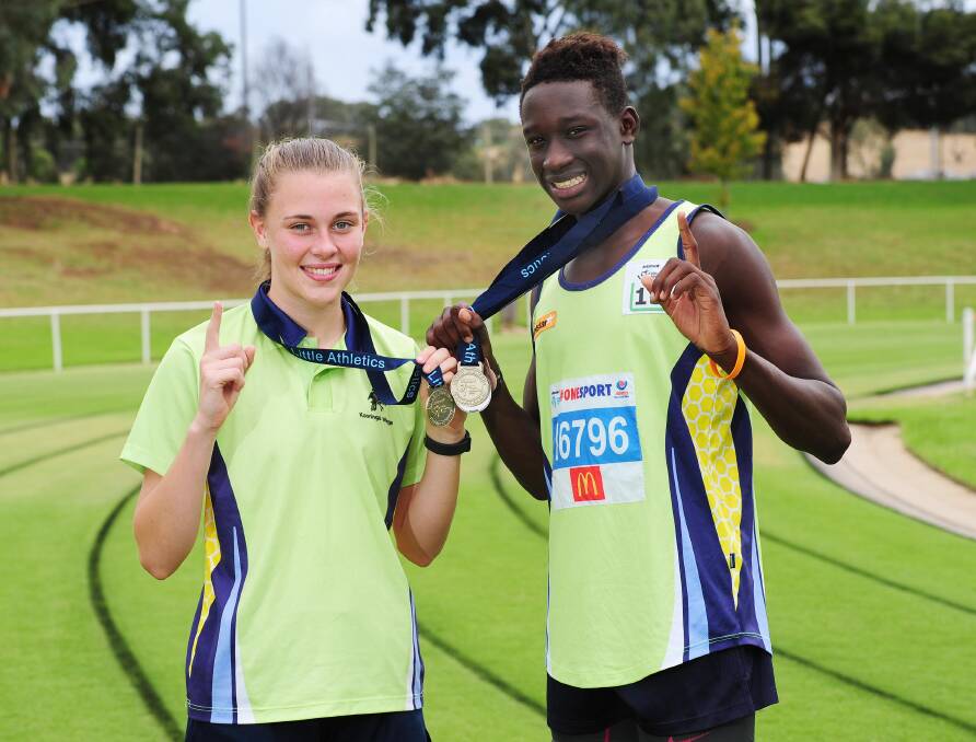 STATE CHAMPS: Hannah Mison and Godfrey Okerenyang from the Kooringal-Wagga club show off their gold medals after enjoying success at the NSW Little Athletics Championships in Sydney. Picture: Kieren L Tilly