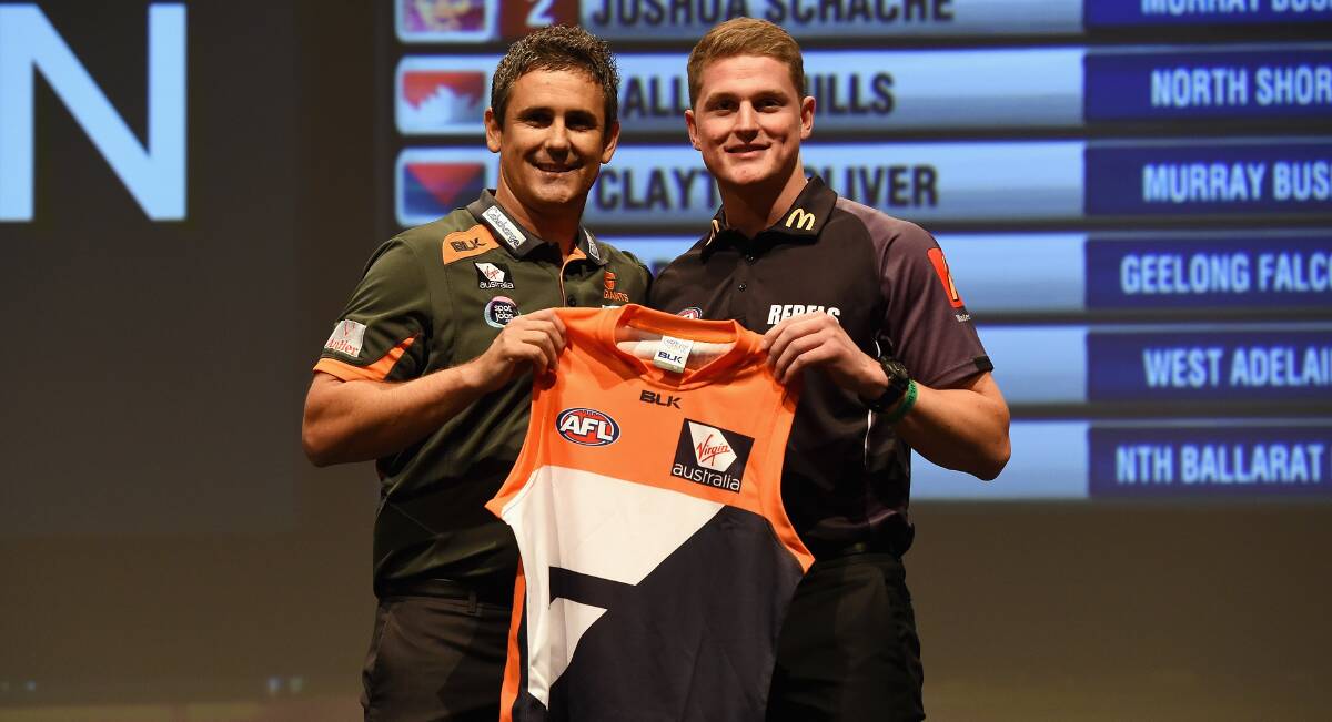 WELCOME ABOARD: Jacob Hopper (right) with GWS coach Leon Cameron after being picked up by the Giants at the AFL draft. Picture: Getty Images