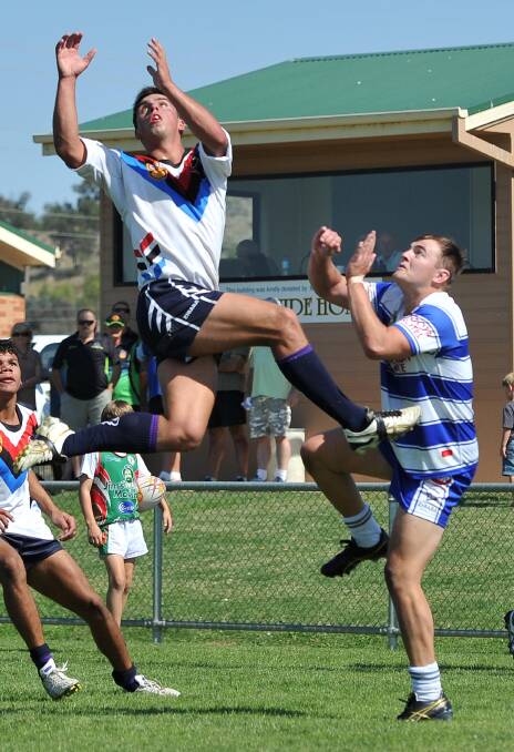 CROSS-CODE SPECIALIST: Ned Mortimer flying high on his way to scoring a try for South City in 2013.