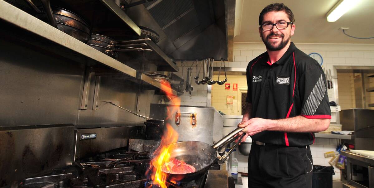 WHOOSH: Wagga's ultimate tong master and Aura executive chef Ryan Dedini lifts the lid to reveal the secrets behind the perfect barbecue. Picture: Laura Hardwick