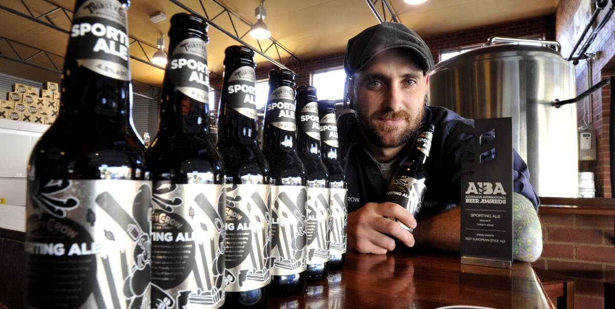 WINNING ALE: Thirsty Crow brewer Braddon Archer displays the brewery's most popular beer, Sporting Ale, which cleaned up a gold medal at the Australian International Beer Awards. Picture: Les Smith