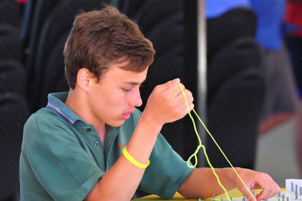CHALLENGE: TRAC's Daniel Cain is all concentration at the Science and Engineering Challenge at Murrumbidgee Turf Club. Picture: Kieren L Tilly