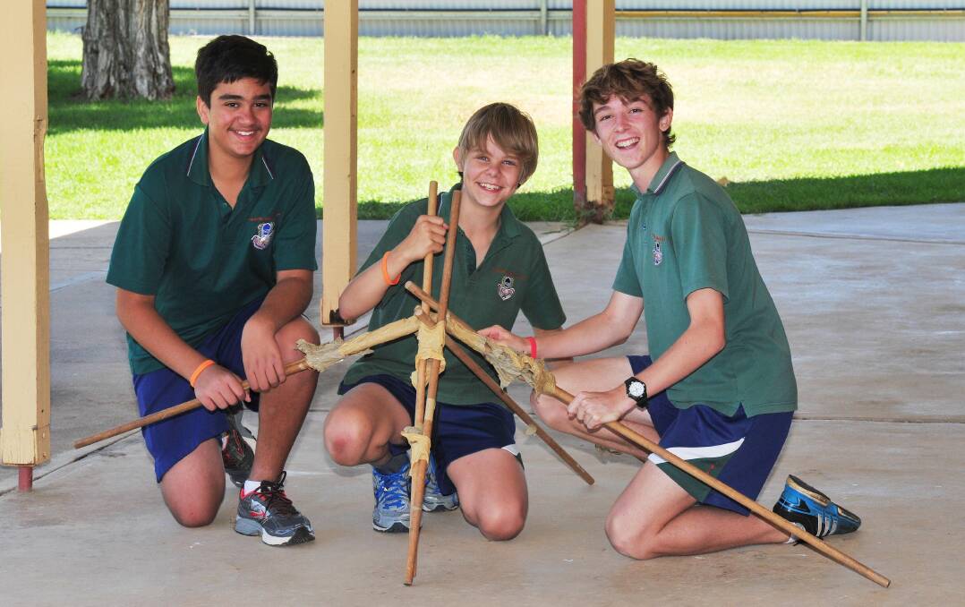 ENGINEERS: Rafael Ghabrial, 14, Mitchell Stevens, 14, and Orlando Holzapfel, 15, test out at a catapult at the MTC. Picture: Kieren L Tilly