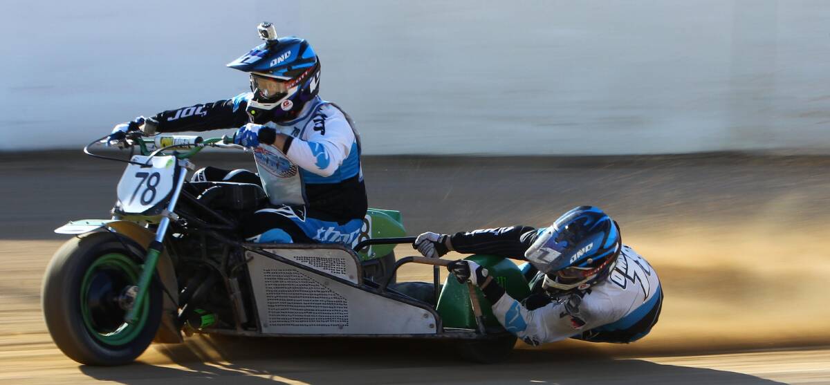 GETTING LOW: Scott Sandow and Wayne O'Melley executing perfect technique as they turn a corner at the Wagga Speedway on Saturday. Picture: Les Smith