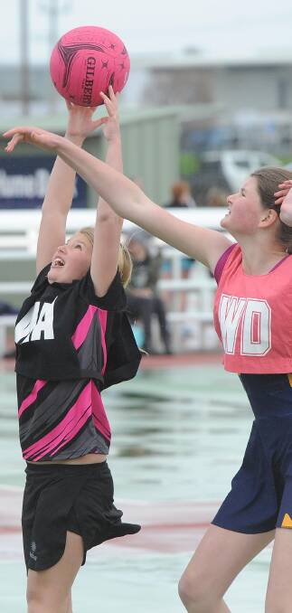 Nixon's Rosie Stoll and Junee's Judy Hopkins in the under 12s netball at Equex on Saturday. Picture: Laura Hardwick