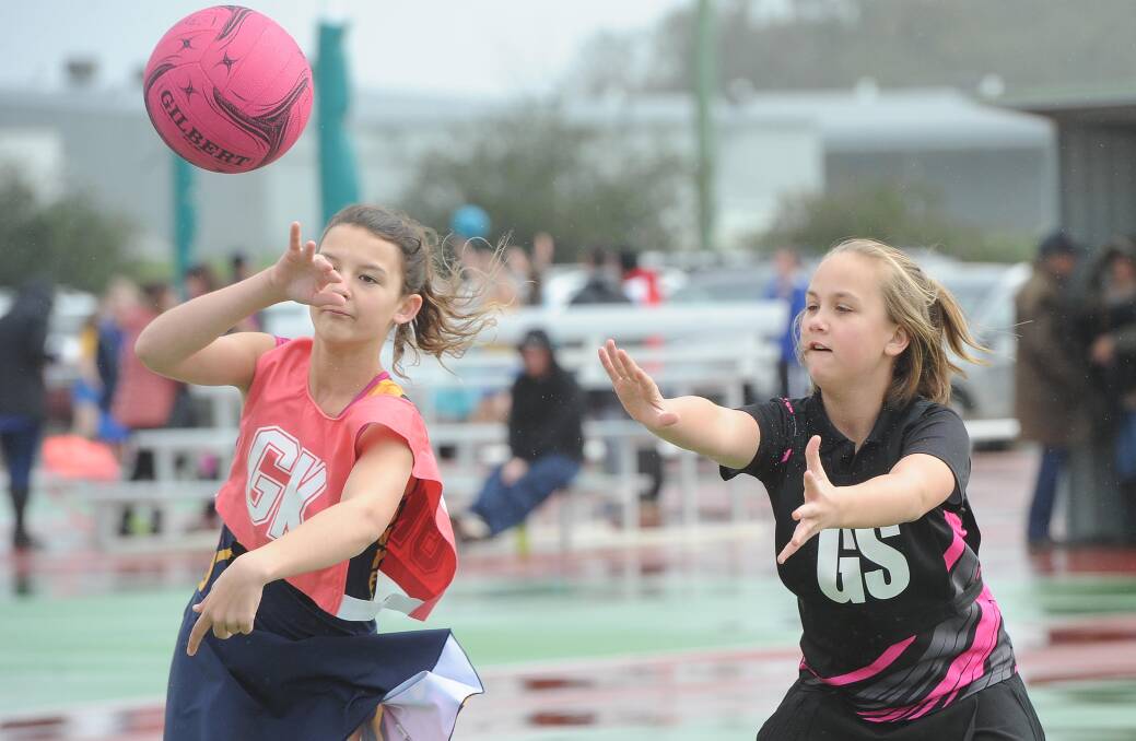 Junee's Mia Phillips and Nixon's Madeline Davis in the under 12s netball at Equex on Saturday. Picture: Laura Hardwick