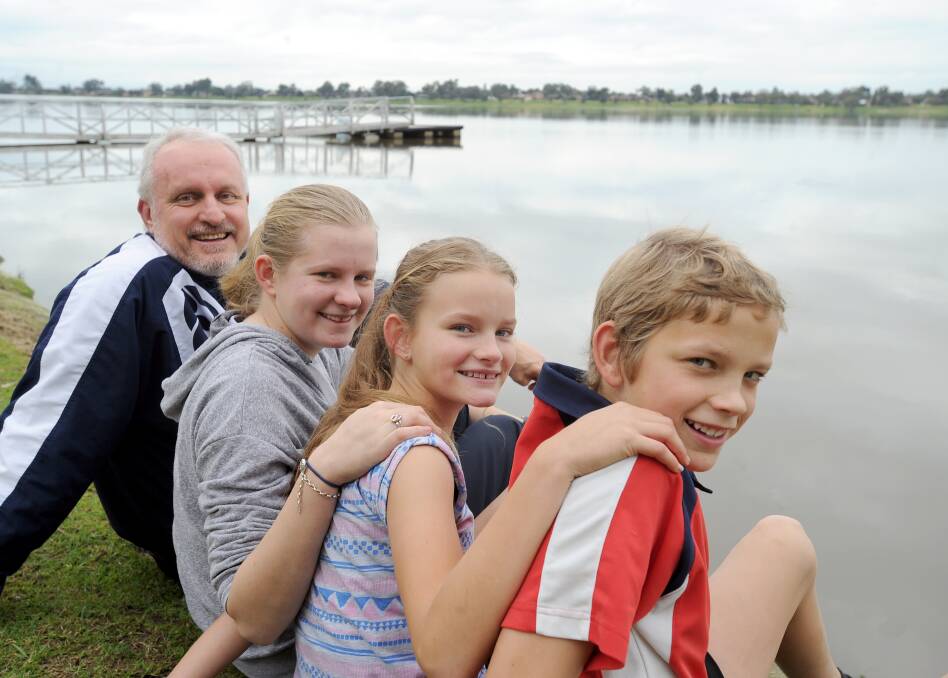 FAMILY MAN: Alastair Mills (left) and three of his four kids Bethany, 17, Hannah, 11, and Jordan, 14 out for a walk at Lake Albert. Picture: Rebecca Fist