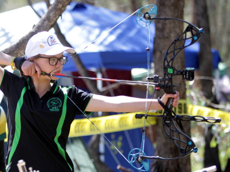YOUNG AND OLD: Jaymie Wood from Brisbane taking part in the World Field Archery Championships at Wokelena Range on Wednesday. Picture: Les Smith