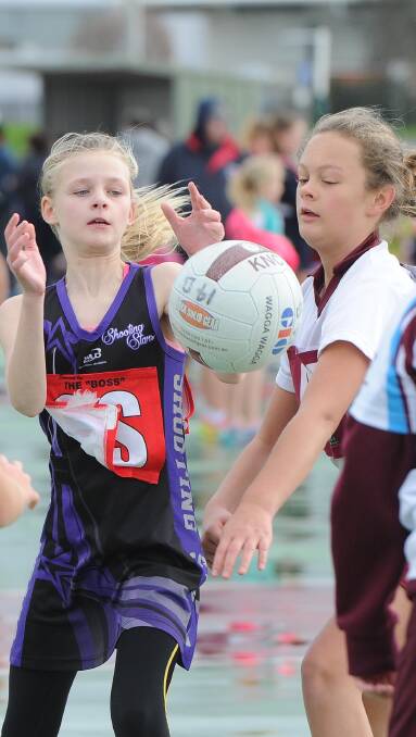 Amelia Deal and Molly Hogdson as Kooringal Maroon verse Shootin Stars Fireworks in the 11 years netball on Saturday. Picture: Laura Hardwick