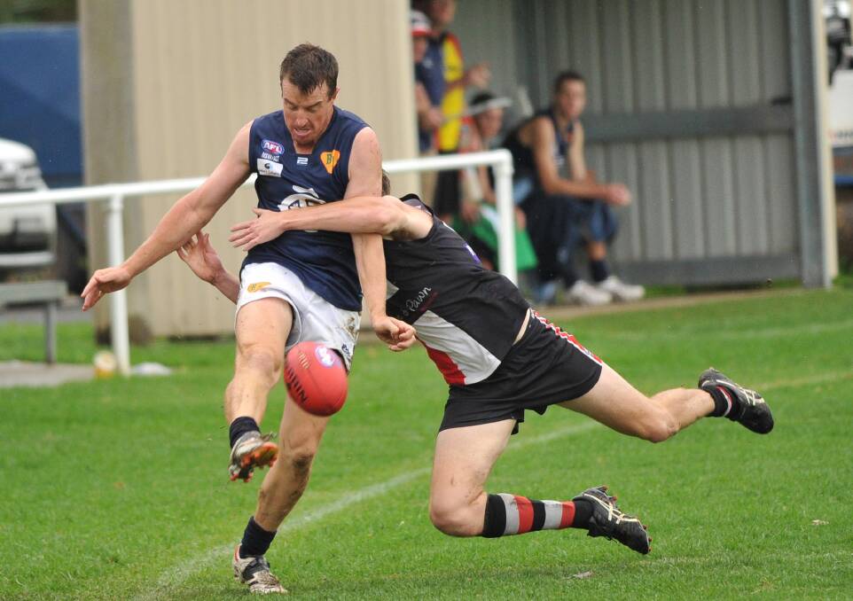 QUICK RELEASE: Coleambally's Nathan Jones keeps his footing as North Wagga's Jeremy Luff tackles him in April. Picture: Laura Hardwick
