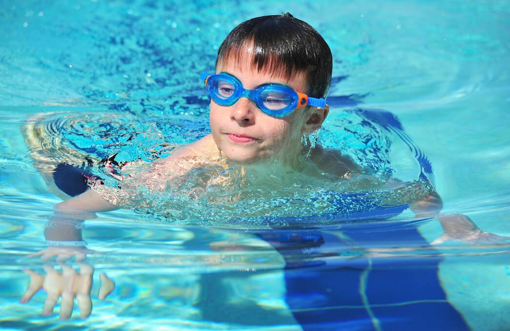 TIME TO LEARN: Kids aged 8-10 can learn to swim through a governement scheme supported by the school, including Ryan Sim, 9, at Forest Hill Swimming Carnival at Oasis on Tuesday. Picture: Kieren L. Tilly