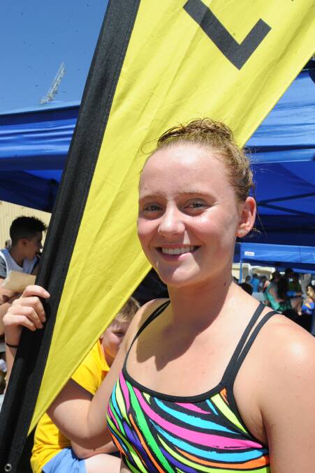 CHAMPION: Emma Nielsen of Lawson house, in and out of the pool all day, has a breather after breaking four records in the 16 years girls' age division at the Kooringal High carnival at Oasis on Wednesday. Picture: Rebecca Fist