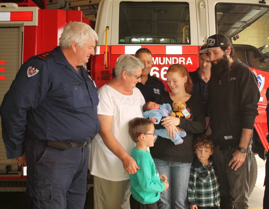 RELIEF: Lacey Deece, two days old on Friday, with family members - mother Monique, brothers Ashley (front, left) and Xavier, father Mitchell (right)  and grandmother Jeannie - and firies from the Cootamundra brigade. Picture: Rebecca Fist