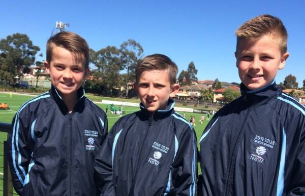 KICKING IT: Riverina under 12 boys Caelan Gray, Will English and Conrad Eyles are punching above their weight, competitive with metro teams in Sydney this week.