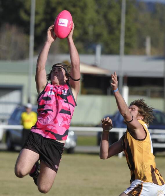 FLYING SAINT: East Wagga Kooringal's Jake Robinson attempting to spoil North Wagga player Jacob May's textbook mark on Saturday. The Saints wore pink for a breast cancer fundraiser. Picture: Les Smith
