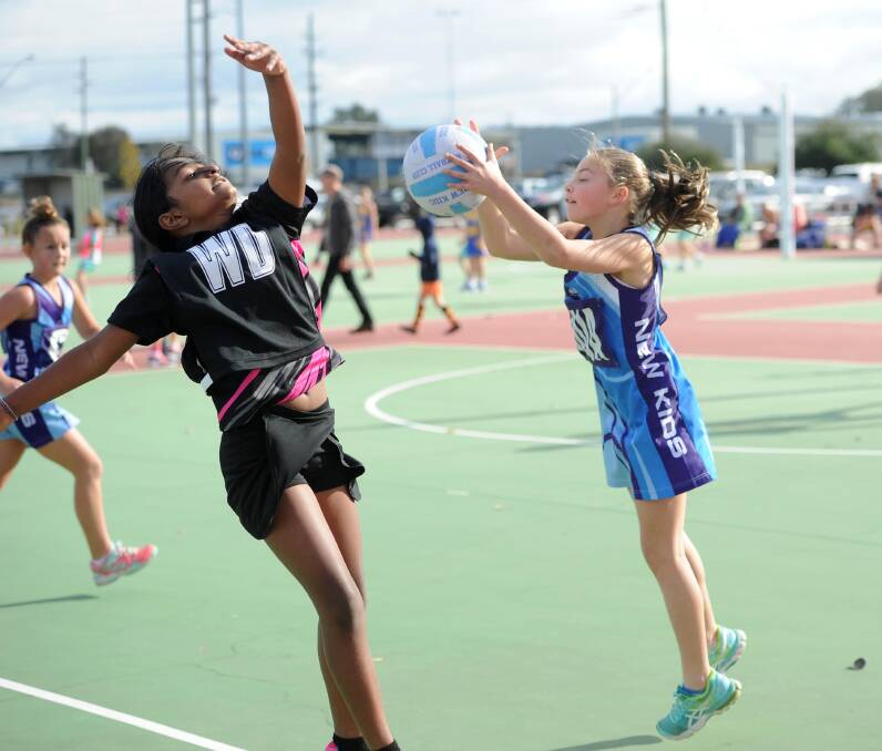CLAIMED: Dinara Piyasiri and Skylah Oliver playing under 11s netball for New Kids Sparklers and Nixon Swifts at Equex on Saturday. Picture: Laura Hardwick