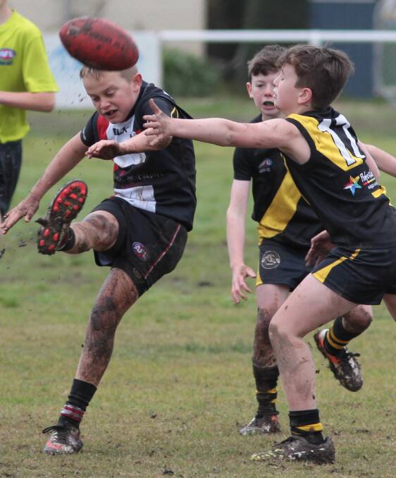 Lewis Pulver makes a clearance as Tigers play North Wagga in the under 11 junior AFL at McPherson Oval on Sunday. Picture: Les Smith