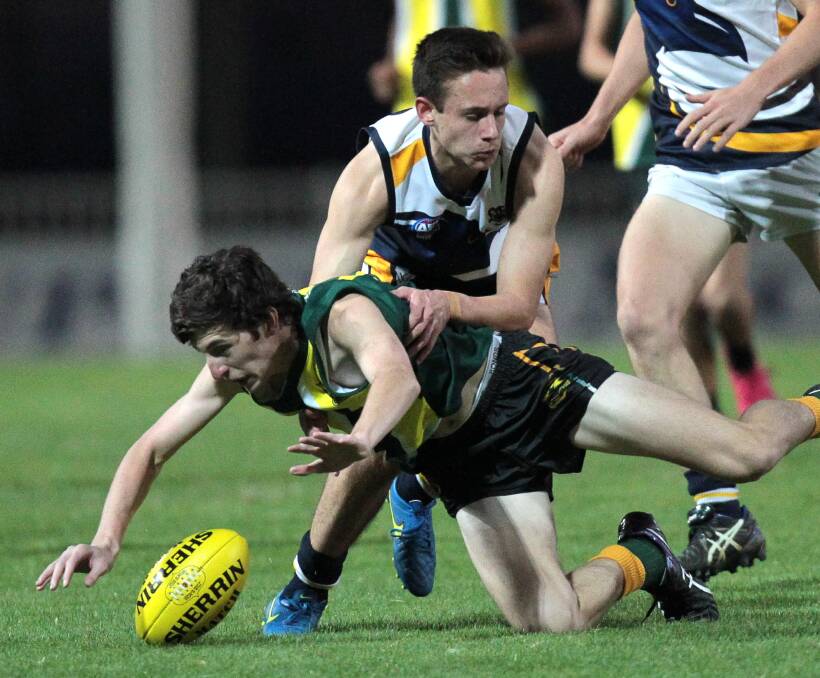 LOSING IT: Mount Austin's Lachlan Watkins hitting the deck at Robertson Oval, tackled by Kooringal High's Evan Nickell on Wednesday night. Picture: Les Smith