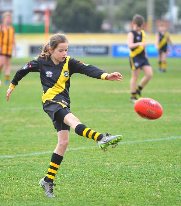 Alex Maiden delivers the ball forward in the under 10s Aussie Rules, as Wagga Tigers face East Wagga-Kooringal Hawks on August 7. Picture: Kieren L. Tilly