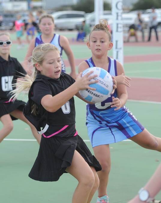 CONTEST: Latisha Peverell and Charlie Neyland playing under 11s netball for New Kids Sparklers and Nixon Swifts at Equex on Saturday. Picture: Laura Hardwick