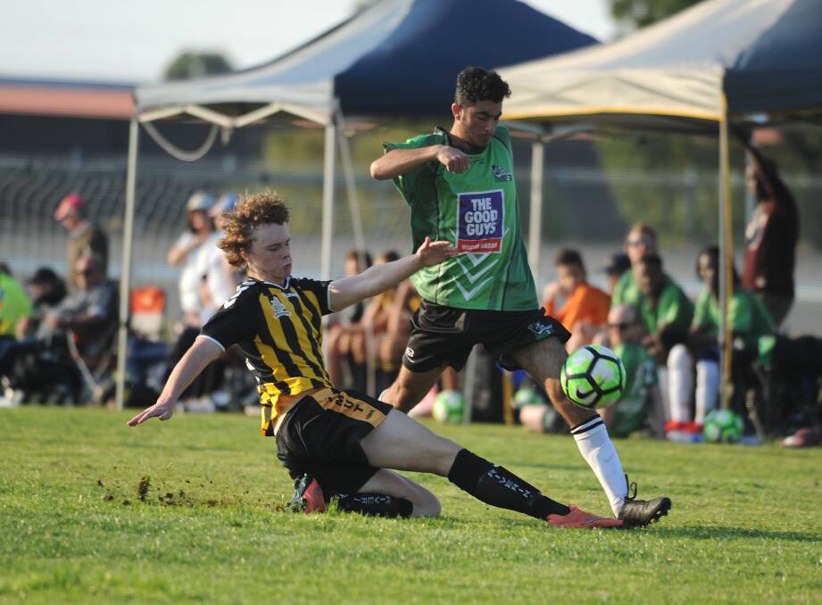 FAST AND FURIOUS: Tumut's Bailey O'Neill slide tackles the ball, slowing-up South Wagga's Ameen Osman at the Showgrounds in round four of the Pascoe Cup. Picture: Laura Hardwick