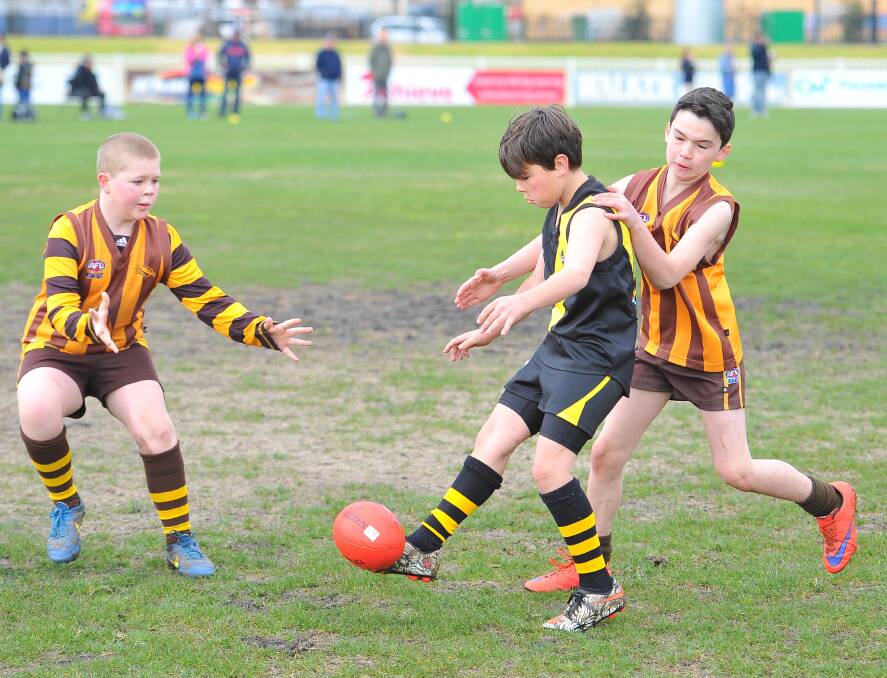 Mitchell White kicks the ball from the contest in the under 10s Aussie Rules, as Wagga Tigers face Hawks on August 7. Picture: Kieren L. Tilly