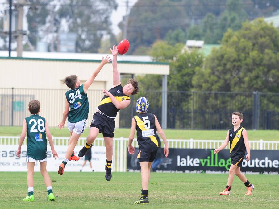 RUCKING: Baxter Crowley in a ball up in the under 11's Australian rules as Wagga Tigers play Coolamon at Robertson Oval on Saturday. Picture: Kieren L. Tilly