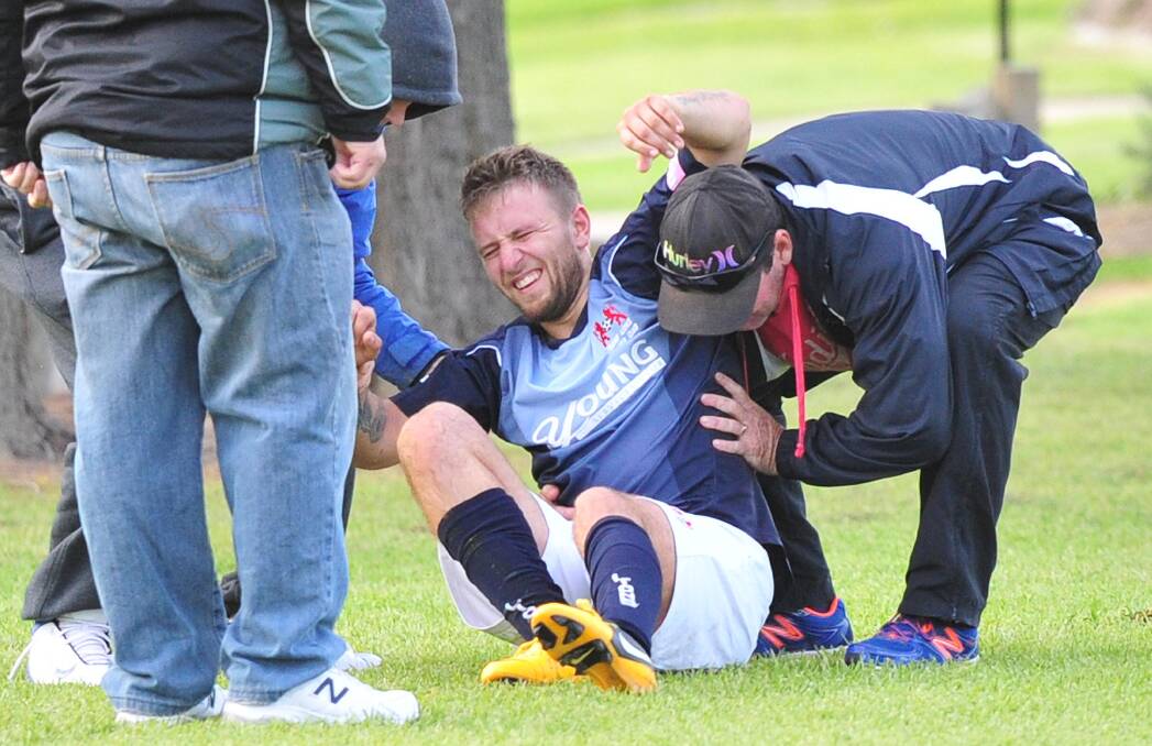 NASTY INJURY: Young player Dmytro Sytin grimacing as he's shifted off the field following a leg injury in a game against Lake Albert on Sunday. Picture: Kieren L. Tilly