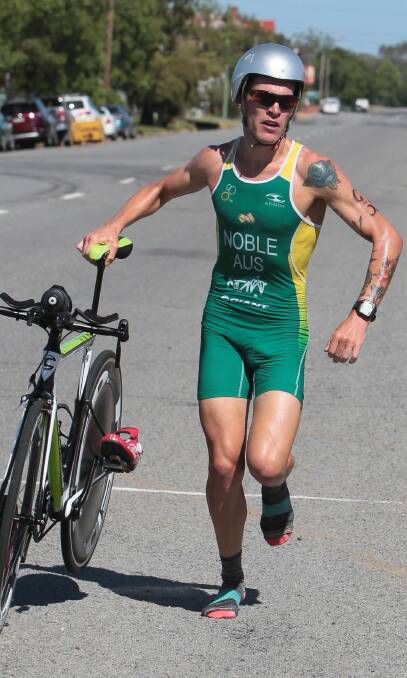 LOCAL LEGEND: Ganmain Triathlon champion Caleb Noble on the homeward stretch, transitioning from the bike leg to the swim leg on Sunday. Picture: Les Smith