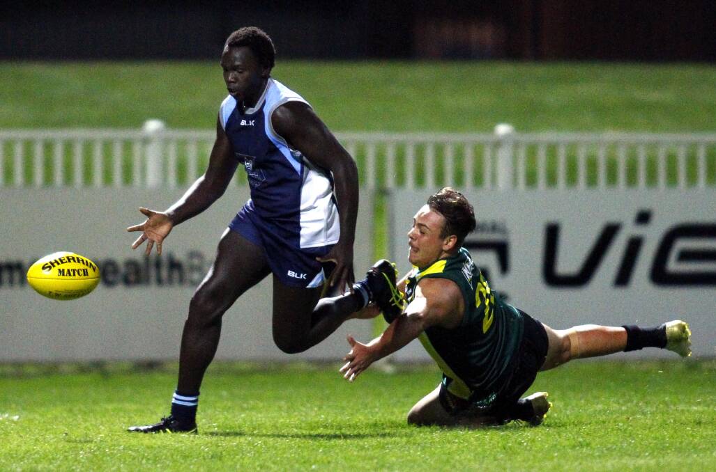 PACE: Wagga High's Benson Ocheing avoids Mount Austin's Maleke Morris at the Carroll Cup at Robertson Oval on Wednesday. Picture: Les Smith
