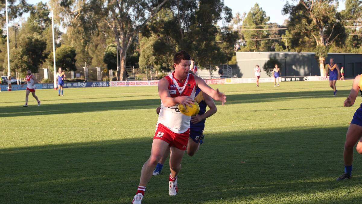 MAN ON: Swans' Michael Duncan looks to get the ball up field before he is tackled by his Narrandera oppostion last weekend. PHOTO: Anthony Stipo
