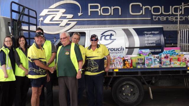 GOOD EFFORT: Ron Crouch Transport social club members present their donated haul which will join the Wagga Toy Run coffers.