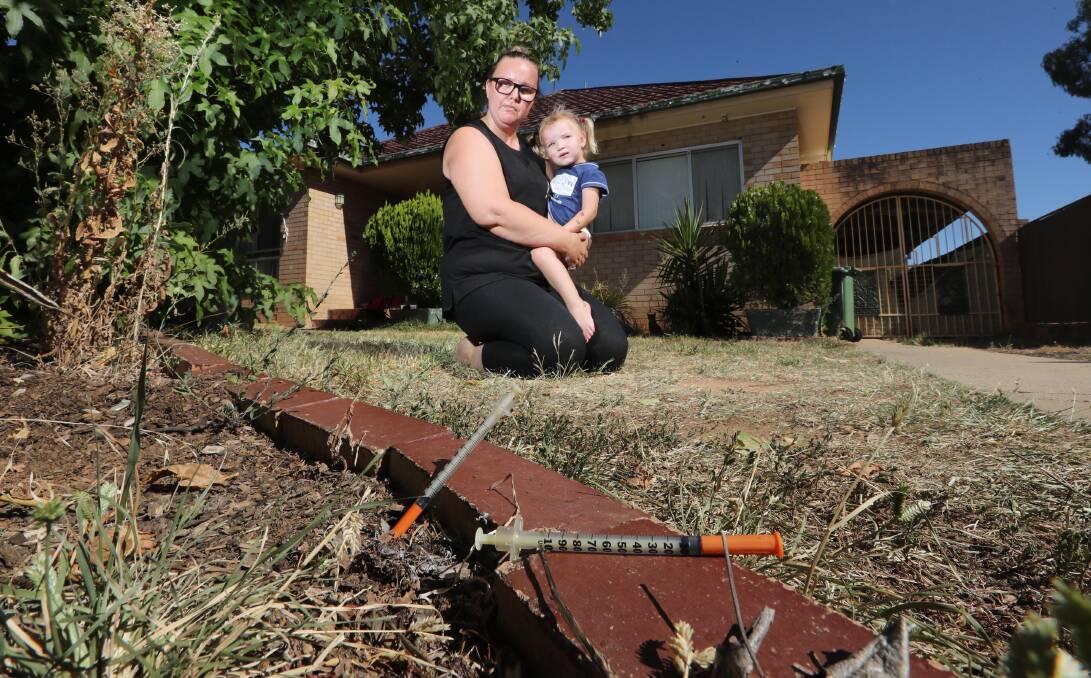 Filthy find: Wagga mother Sally-anne Smith, with two-year-old Violet Smith-Buckby, was left furious after she spotted two dirty needles in the front garden of her Mount Austin home on Monday morning. Picture: Les Smith 