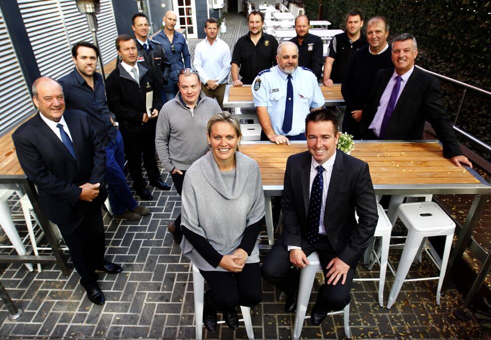 Competitors unite: Racing MP Paul Toole and Romanos publican Belinda King, with Wagga MP Daryl Maguire and the city's publicans, at the "Ask for Angela" initiative launch. Picture: Les Smith