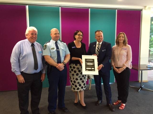 TAKING A STAND: TAFE NSW Regional chief Kerry Penton, with White Ribbon ambassador and wagga detective Phil Malligan, TAFE's people and
safety business partner Graeme Knott, community services head teacher Di Sutherland and Wagga's superintendent Bob Noble.