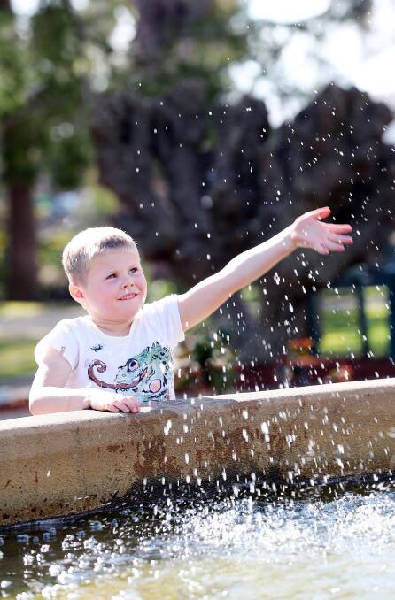 Spring has sprung: Wagga's Zac Snowden, 5, takes time out from his busy schedule to splash in the water at Victory Memorial Gardens. Picture: Kieren L Tilly 